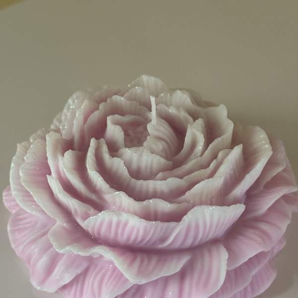 Pink rose-shaped candle with layered petals