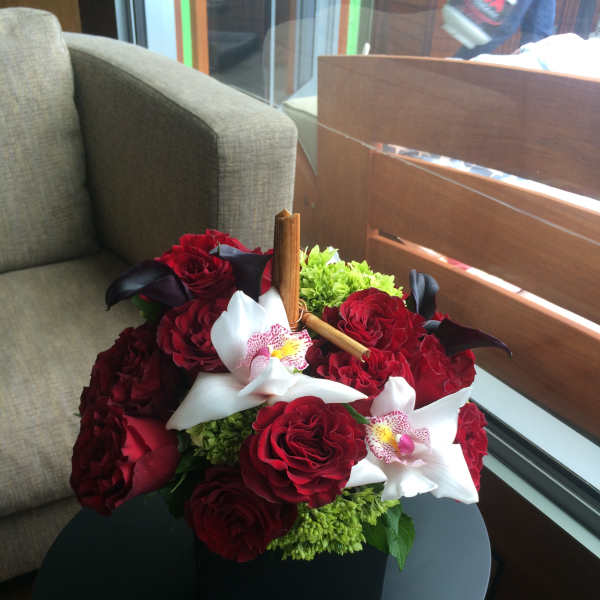 Bouquet of red roses with white orchids in a black box