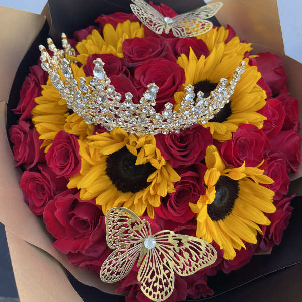 Bouquet of red roses and yellow sunflowers with jeweled butterfly accents