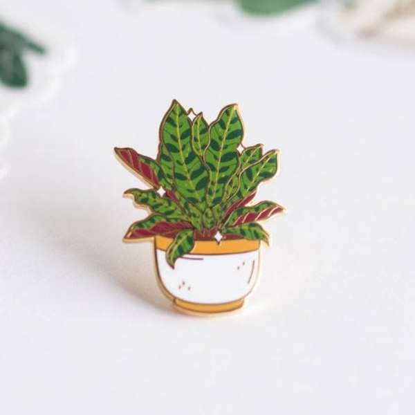 Enamel pin of a potted leafy plant