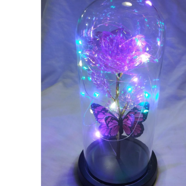 Purple light-up rose in a clear dome with a butterfly decoration