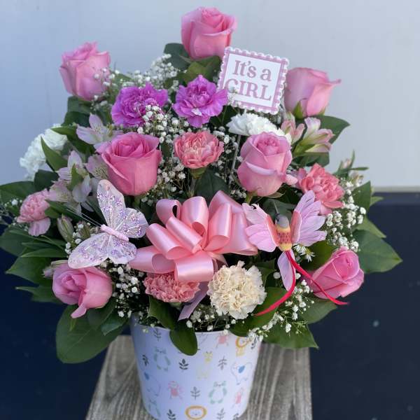 Pink rose and carnation arrangement in a decorative box with an "It's a GIRL" sign