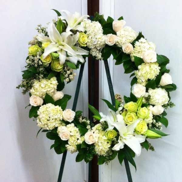 White floral wreath on a standing easel