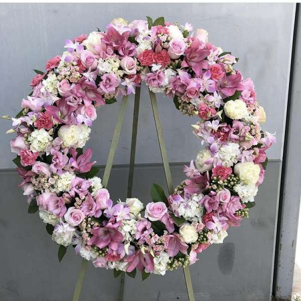 Pink and white floral wreath on an easel