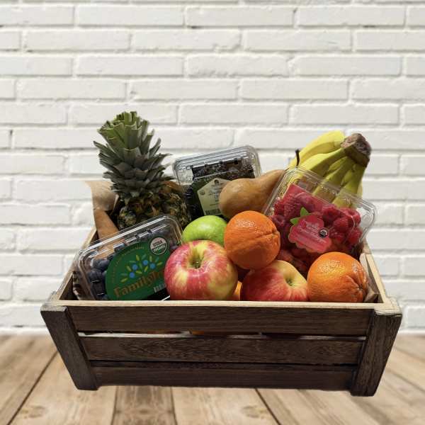 Wooden crate filled with assorted fruit and berry containers