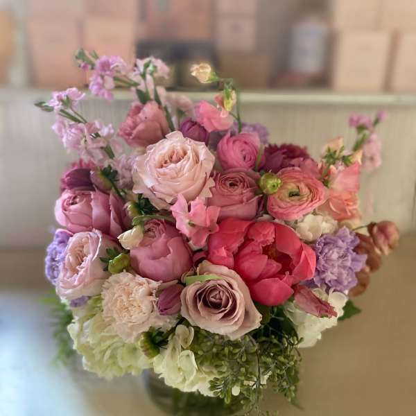Pink and lavender bouquet of mixed flowers in a glass vase