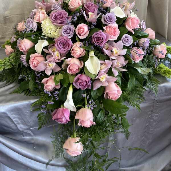 Large bouquet of pink and lavender roses with orchids and white calla lilies