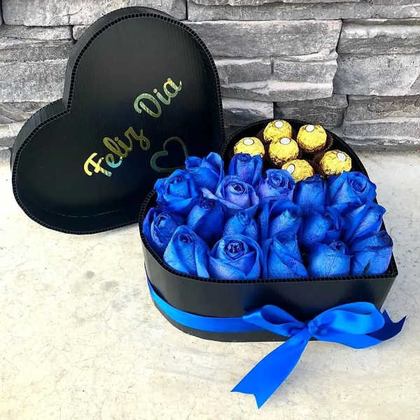 Heart-shaped box with blue roses and gold-wrapped chocolates