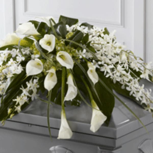 White floral spray arranged on a casket