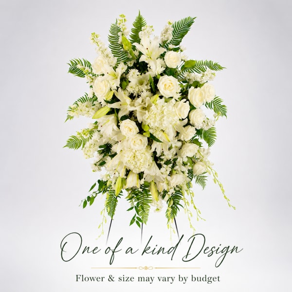 Tall white floral arrangement with roses and lilies on a stand