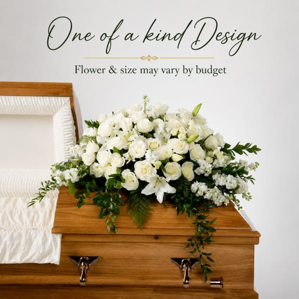 White floral arrangement on a wooden casket