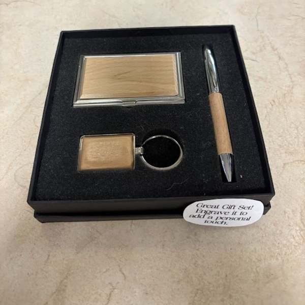 Gift set with a compact mirror, keychain, and pen in a black box