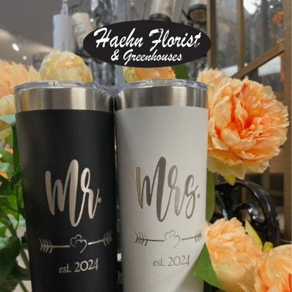 Two engraved tumblers with Mr. and Mrs. text beside peach flowers