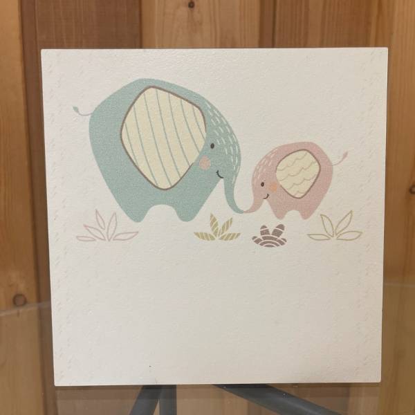 A card with two cartoon elephants touching trunks.