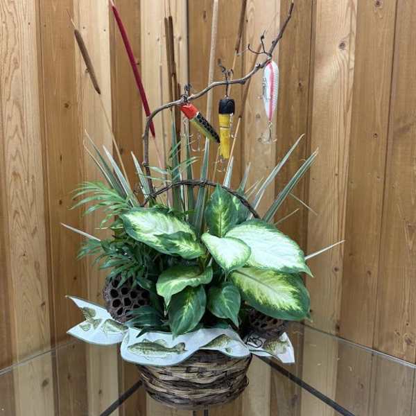 Basket arrangement with assorted green plants and fishing lures