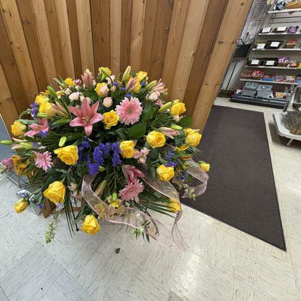 Large mixed bouquet with yellow roses, pink lilies, and purple accents