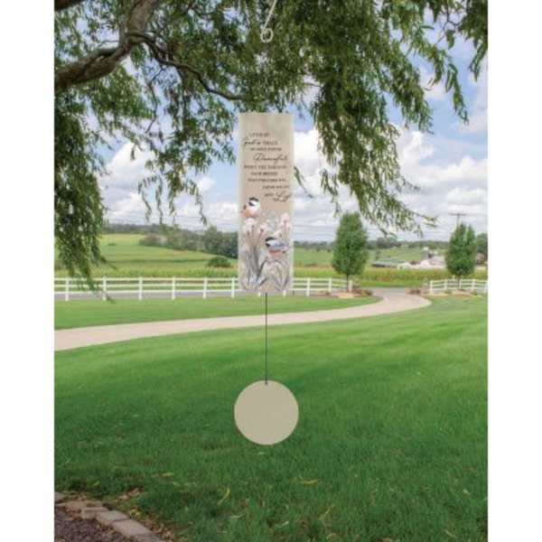 Hanging memorial sign with floral accents in a grassy outdoor setting