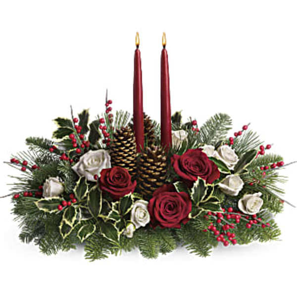 Holiday centerpiece with red candles, roses, pinecones, and evergreen branches