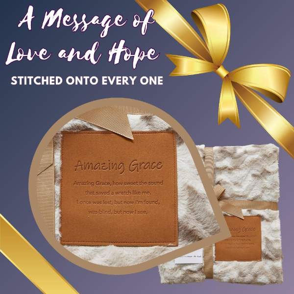 Fur-textured blanket with an embroidered "Amazing Grace" patch and gold ribbon