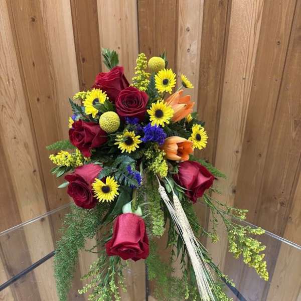 Bouquet of red roses, yellow daisies, and orange lilies