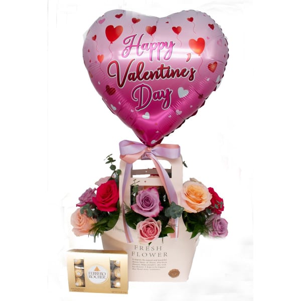 Heart-shaped Valentine balloon above a rose gift box with chocolates
