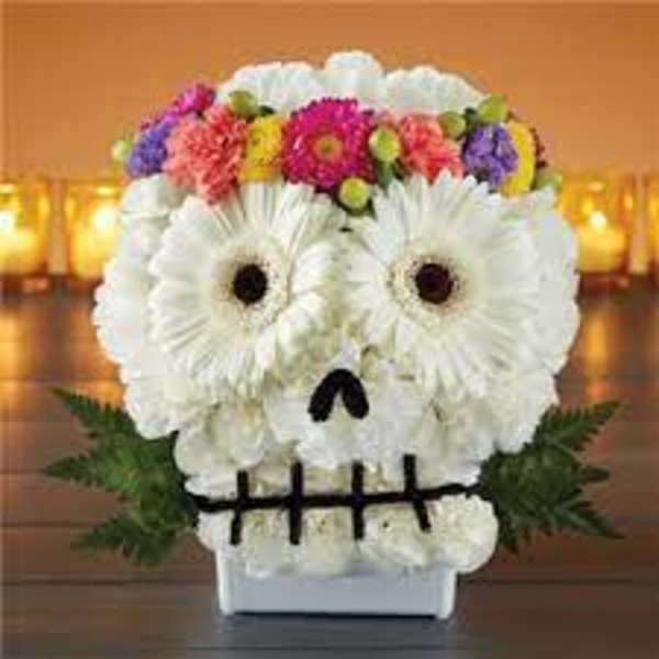 Skull-shaped floral arrangement with white daisies and colorful blooms