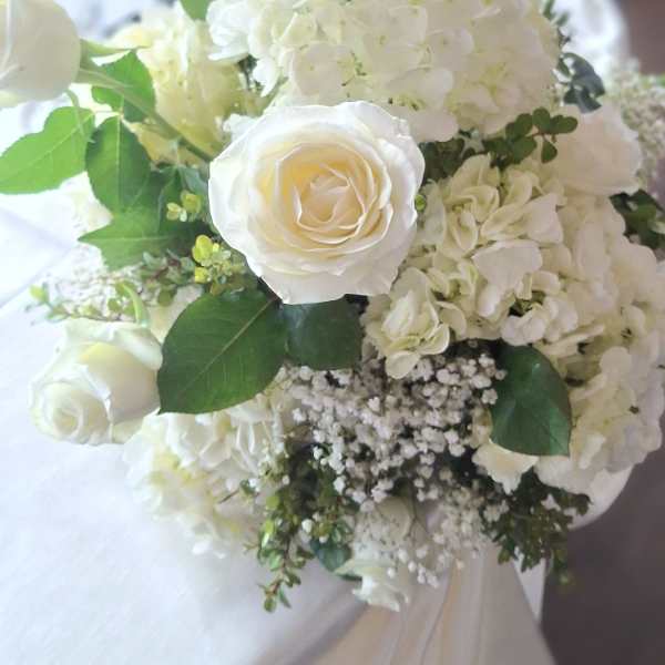 White rose and hydrangea bouquet with green foliage