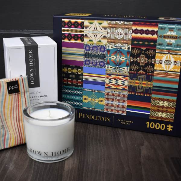 Candle, boxed candle, striped pouch, and a patterned puzzle box