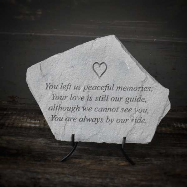 Memorial stone with an engraved sympathy verse and heart icon