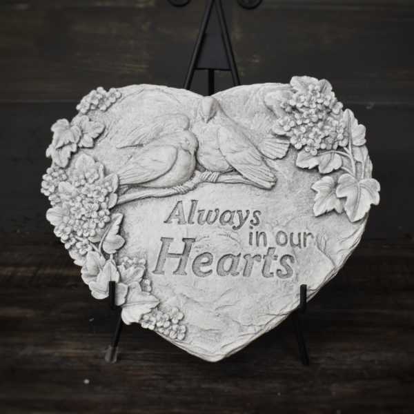 Heart-shaped memorial plaque with birds and flowers