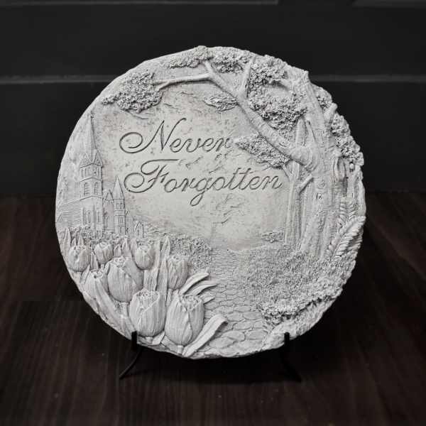 Round decorative plaque with tulips and the words Never Forgotten