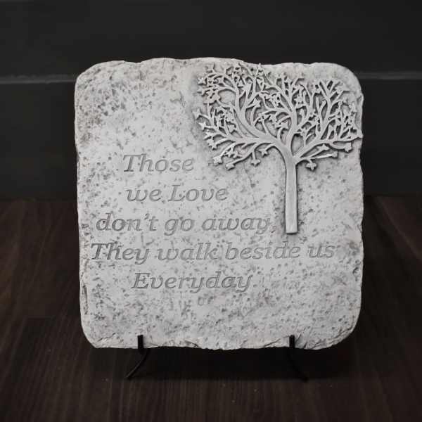 Decorative stone plaque with a tree and memorial quote