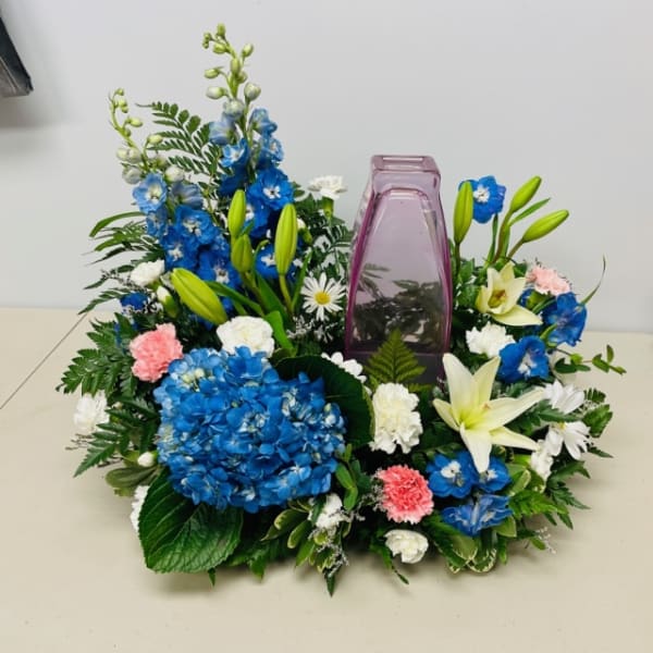 Blue and white floral wreath with a purple vase in the center