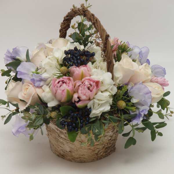 Basket arrangement of pink and white flowers with lavender accents