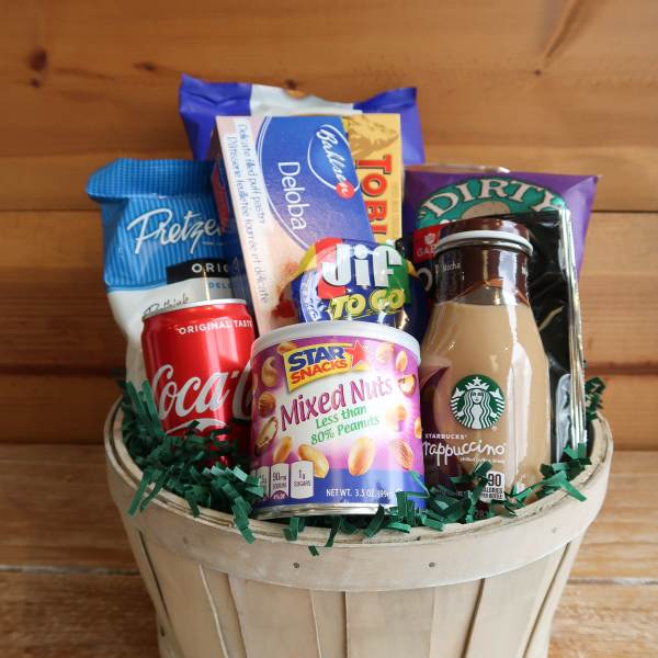 Basket of assorted snack and drink items in a wooden container