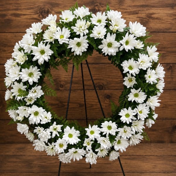 White daisy wreath on a black stand
