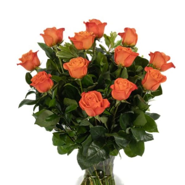 Orange roses arranged in a clear glass vase