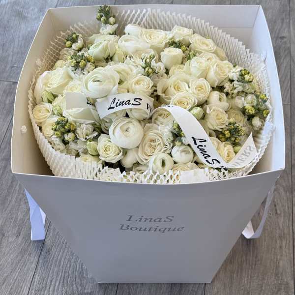 White rose bouquet in a gift box with ribbon