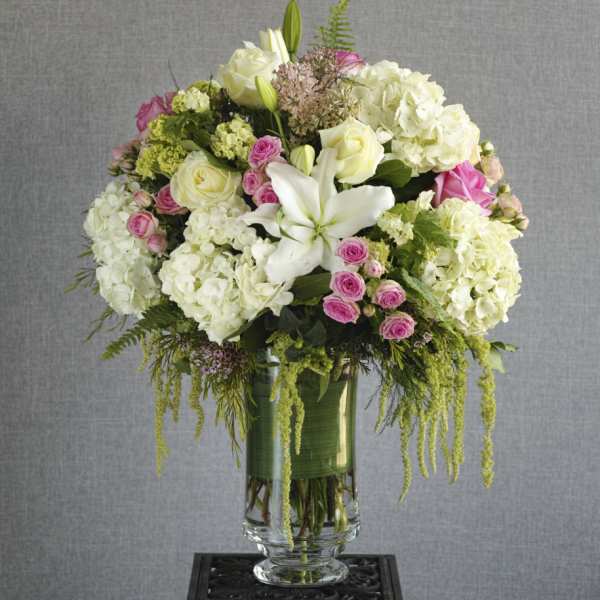 White and pink floral arrangement in a glass vase
