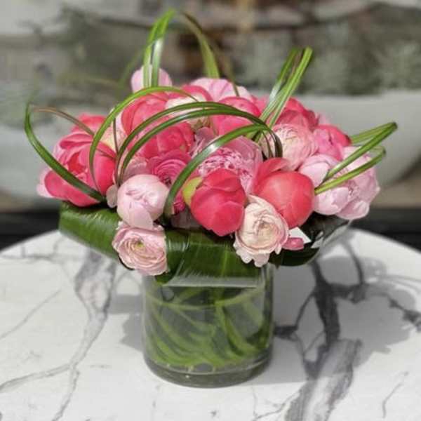 Pink ranunculus bouquet in a clear glass vase