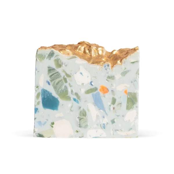 Decorative soap bar with a gold top and embedded pastel pieces