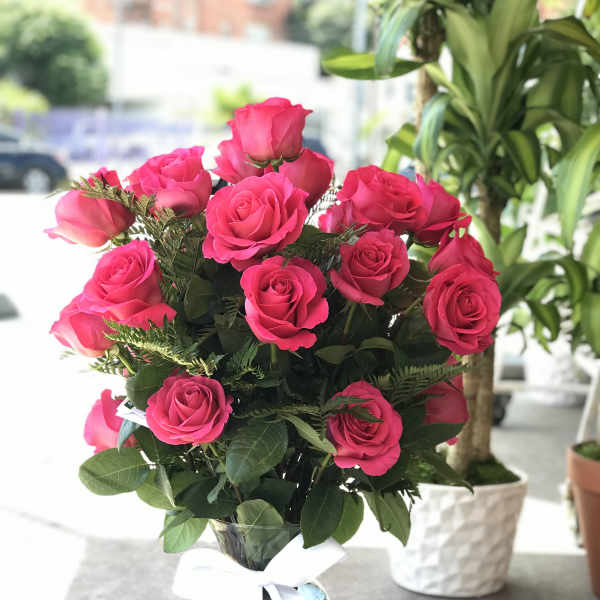 25 Hot pink roses in glass vase