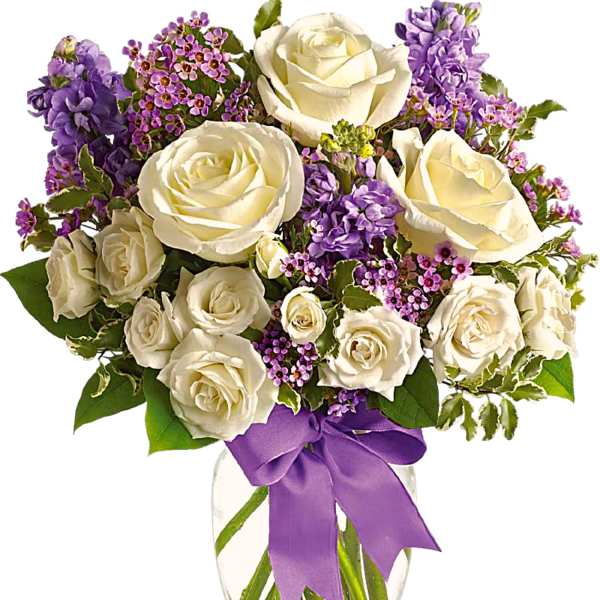 White roses and purple flowers in a clear glass vase with a purple ribbon
