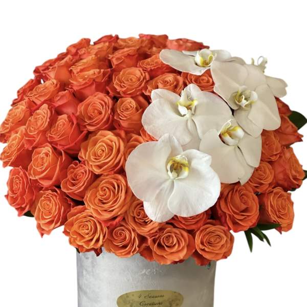 Orange rose arrangement with white orchids in a silver box