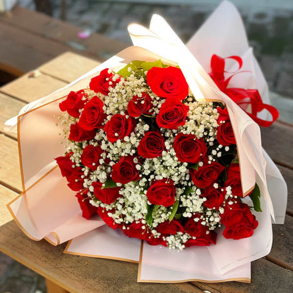 Bouquet of red roses with white baby's breath in white wrapping