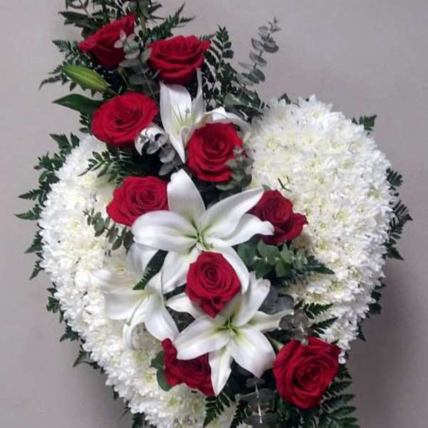 Standing floral wreath with red roses, white lilies, and white chrysanthemums