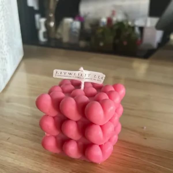 Pink bubble cube candle on a wooden table