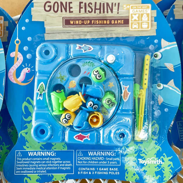 Packaged wind-up fishing game with colorful fish and poles
