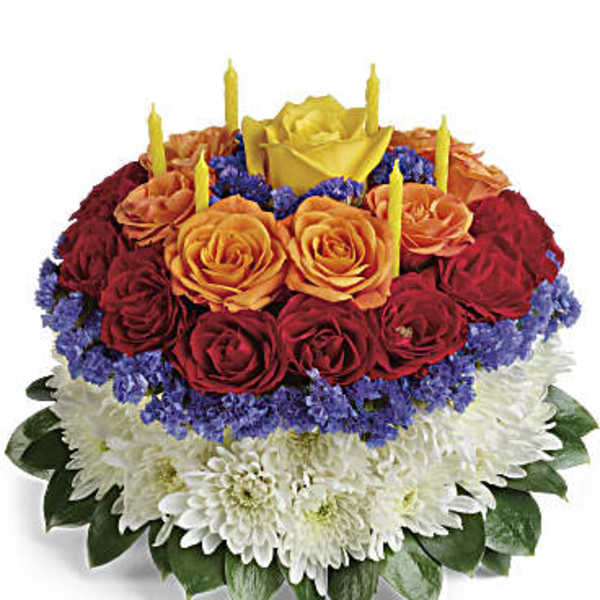 Round arrangement of red and orange roses with white chrysanthemums and candles