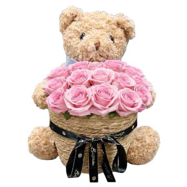 Teddy bear holding a basket of pink roses with a black ribbon